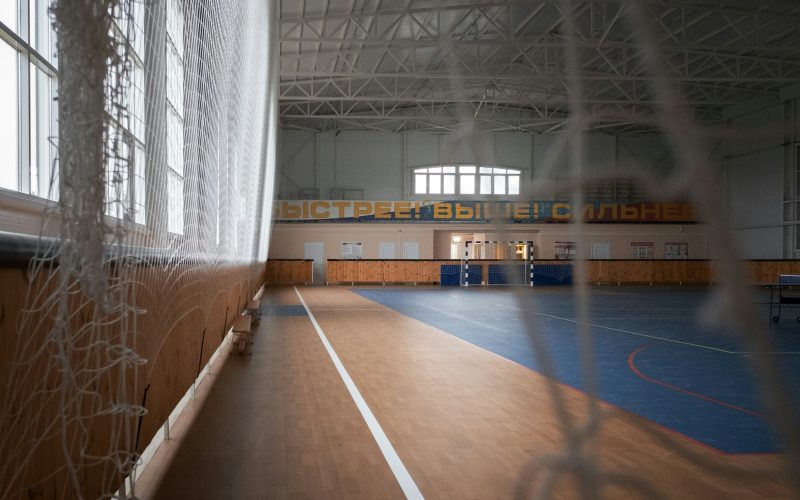 ein-grosser-fitnessraum-im-innenbereich-mit-parkettboden-Ft1VsaXvnRc